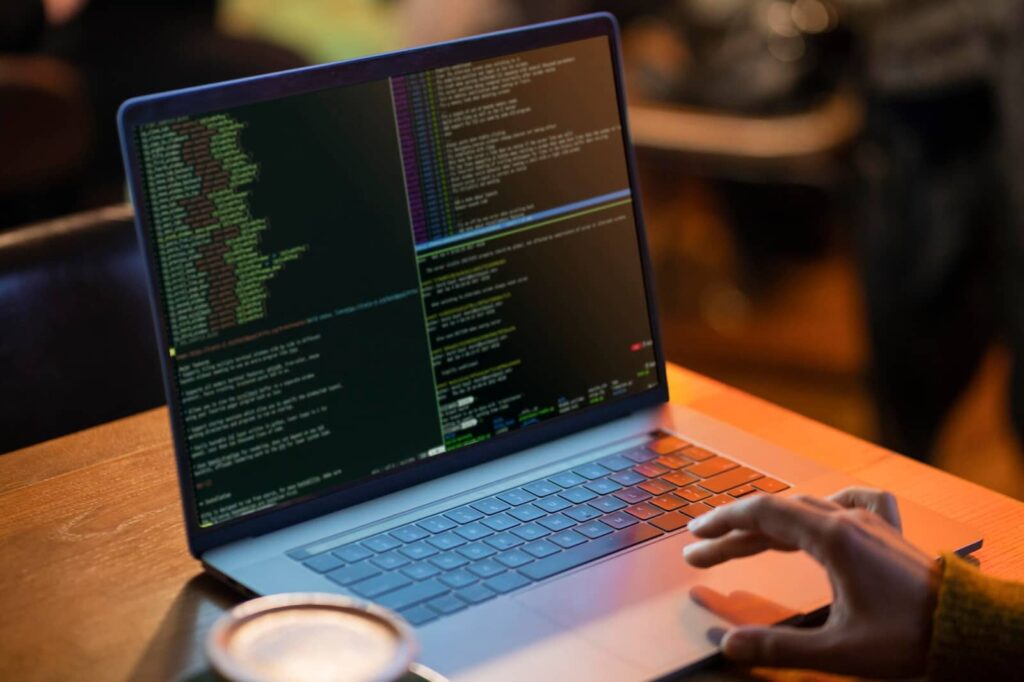 Man in front of computer working with code